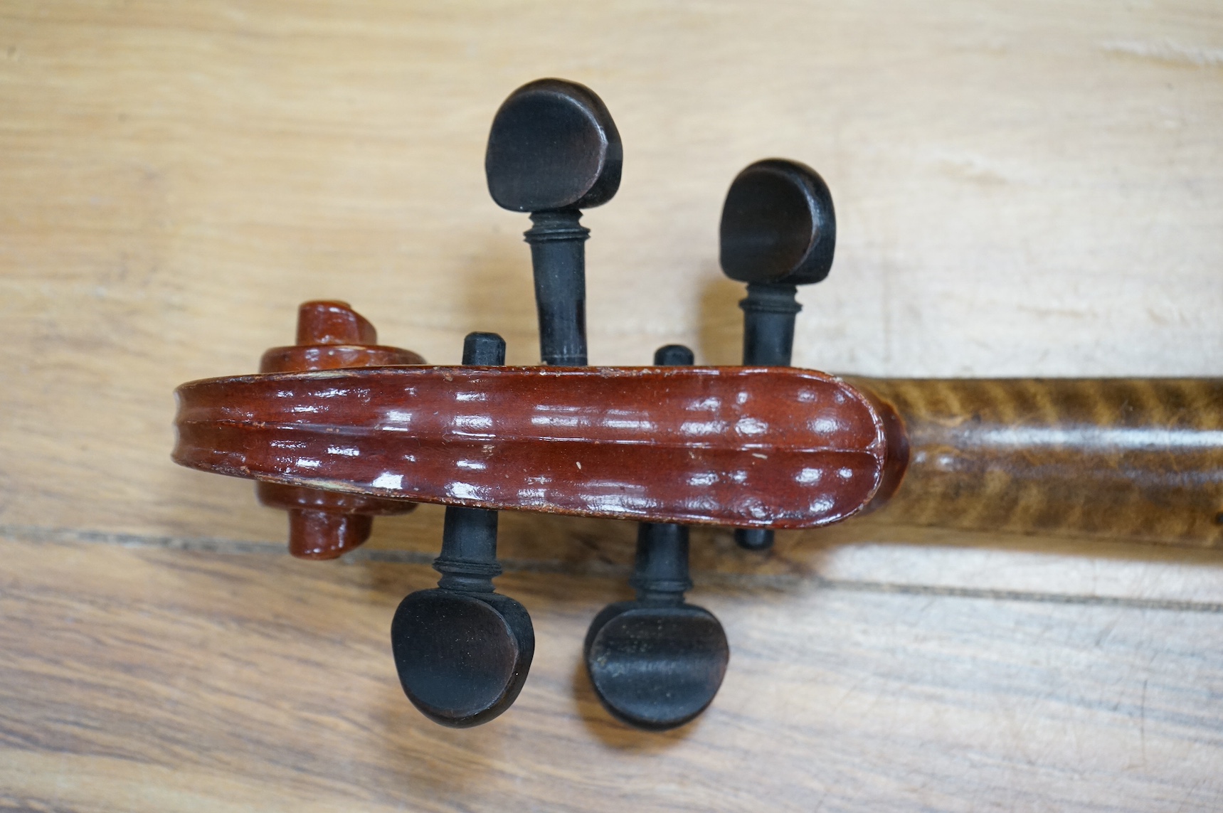 An early 20th century violin, possibly Czech, with internal label for ‘Maidstone Orchestra Association, Oxford St. London’ and bow, in case, length of back of body, 36cm., Condition - fair to good.